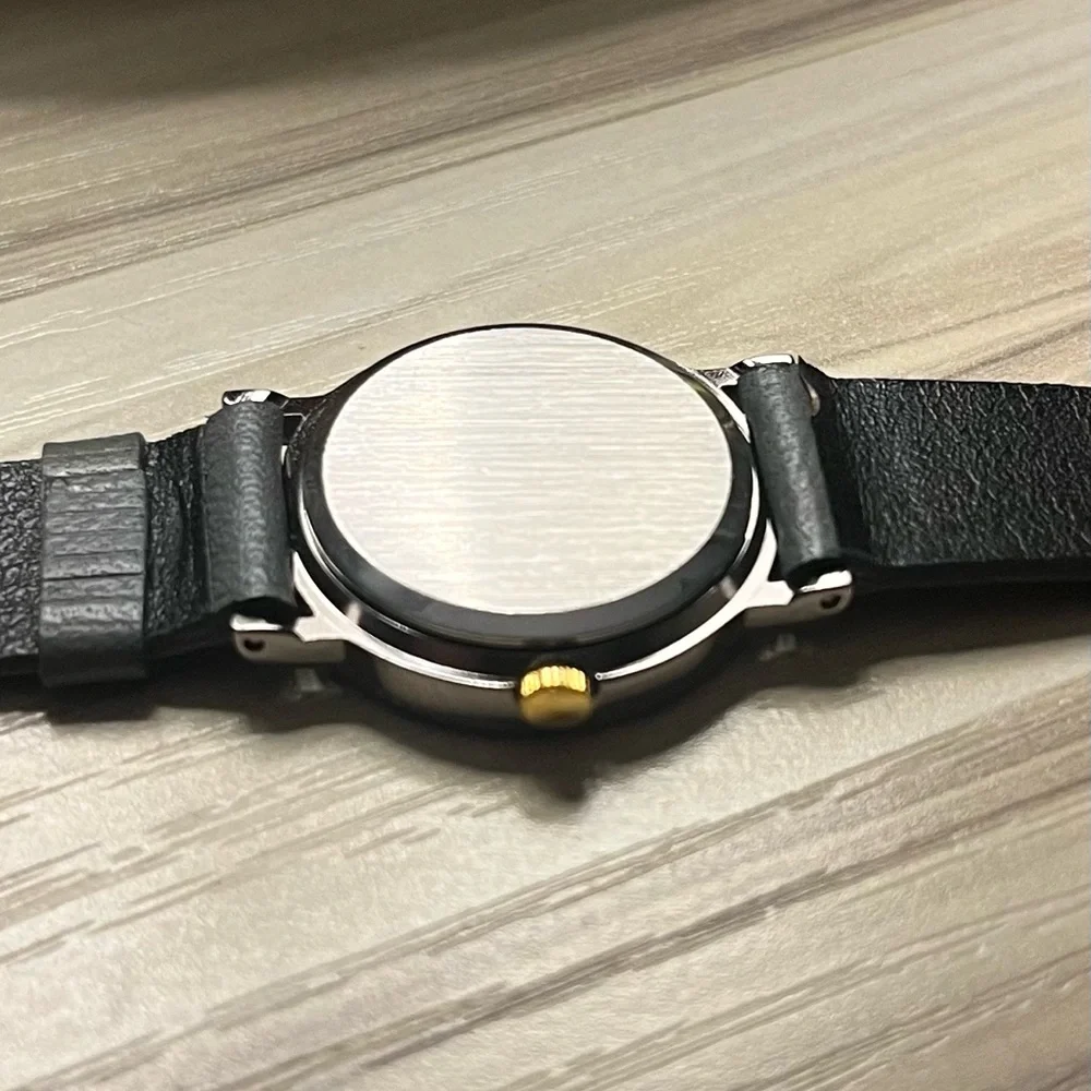 Gucci branded watch with grey leather strap and gold details
